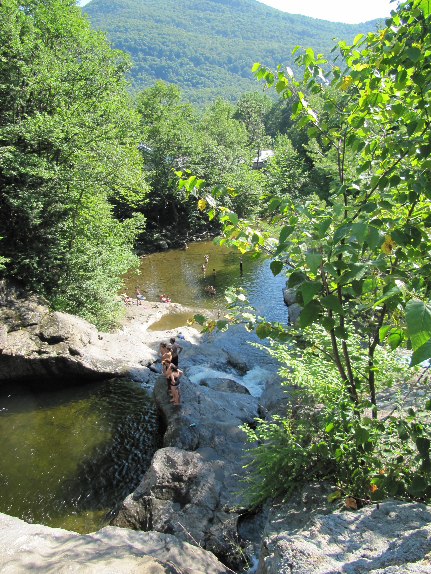 Visitors gather near the rock pools and cascades at Bolton Potholes.