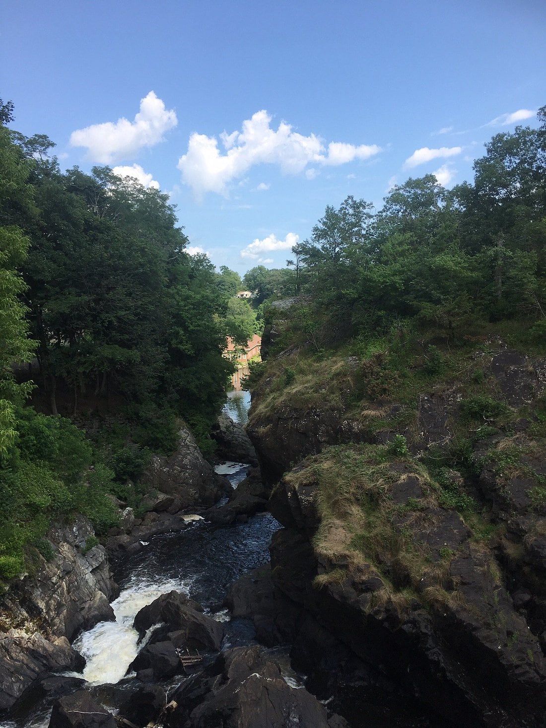 Steep rock walls frame the dark water below Yantic Falls.