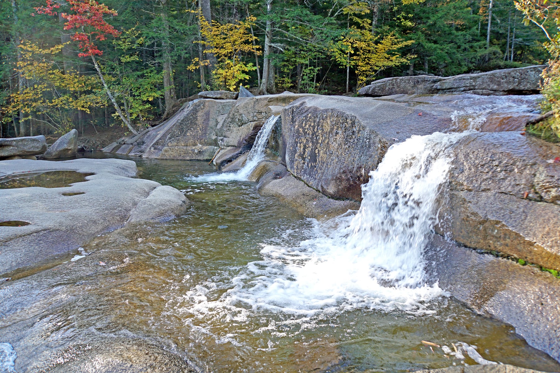 Lucy Brook cascading over smooth granite into shallow pools at Diana's Baths.