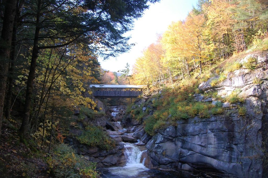 Covered bridge above the rocky stream channel at Flume Gorge in Franconia Notch.