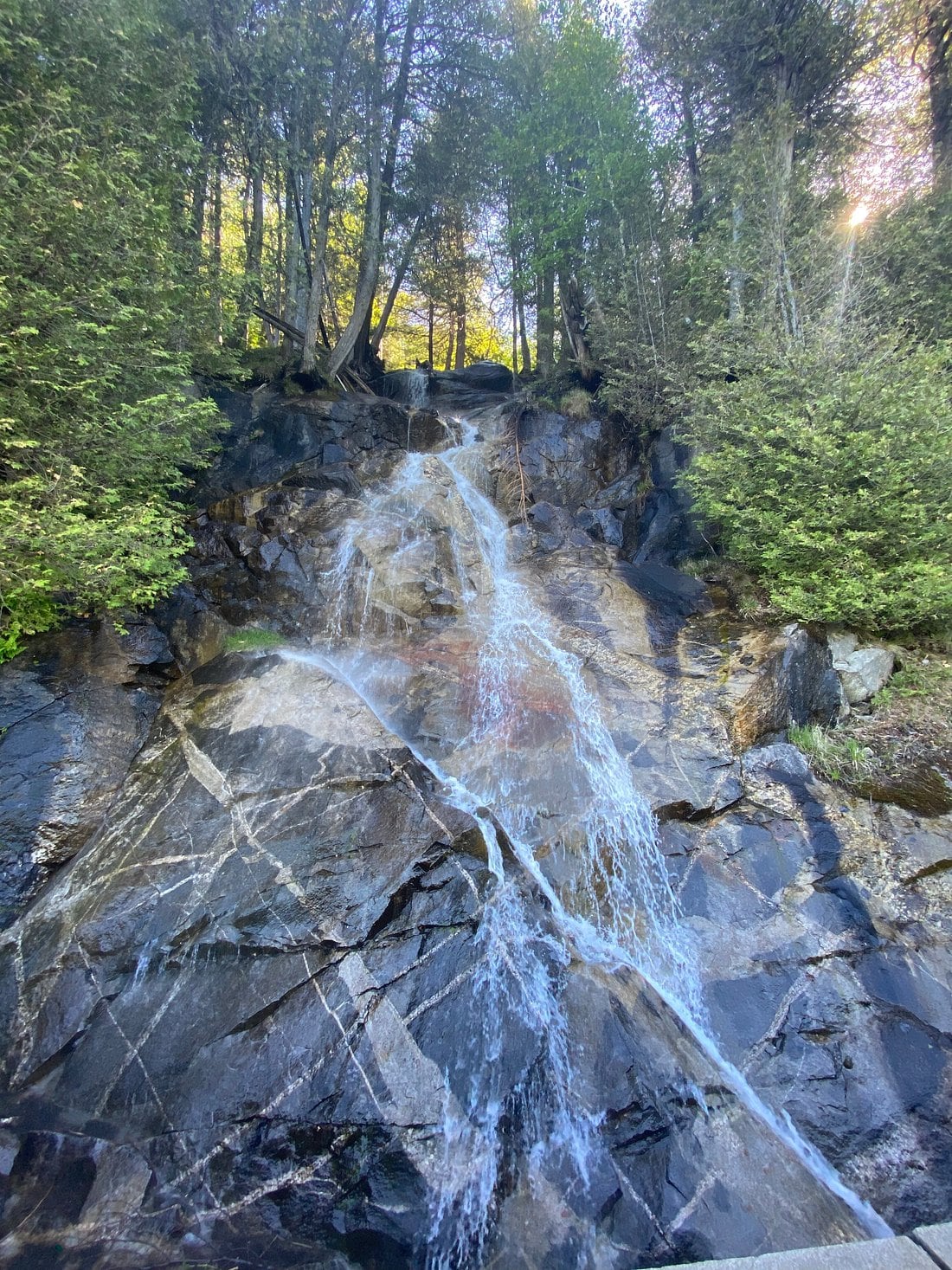 A small forest cascade on dark rock near the Lake Willoughby area in Vermont.