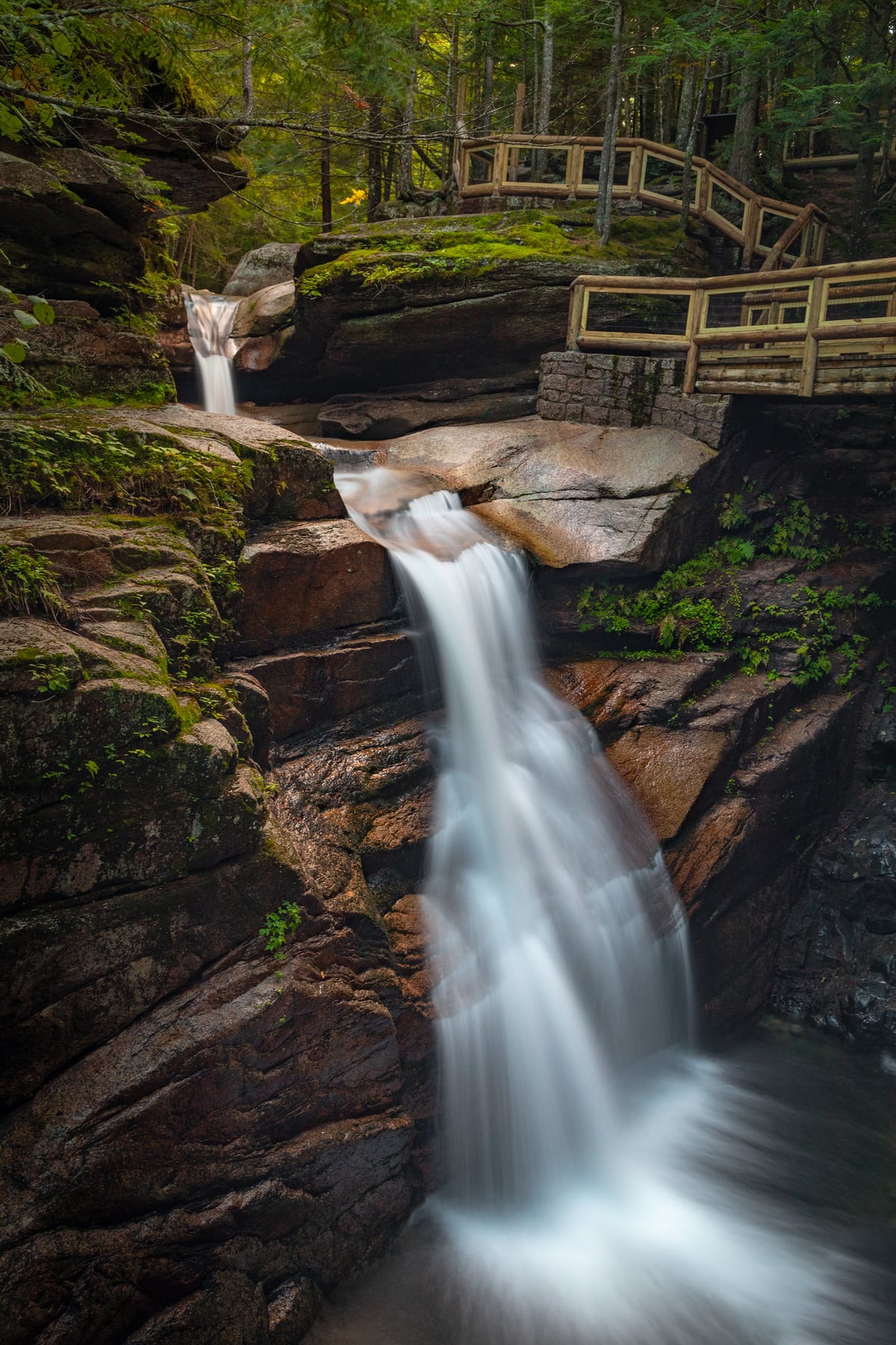 A shadowed pool sits below the carved rock walls at Sabbaday Falls.